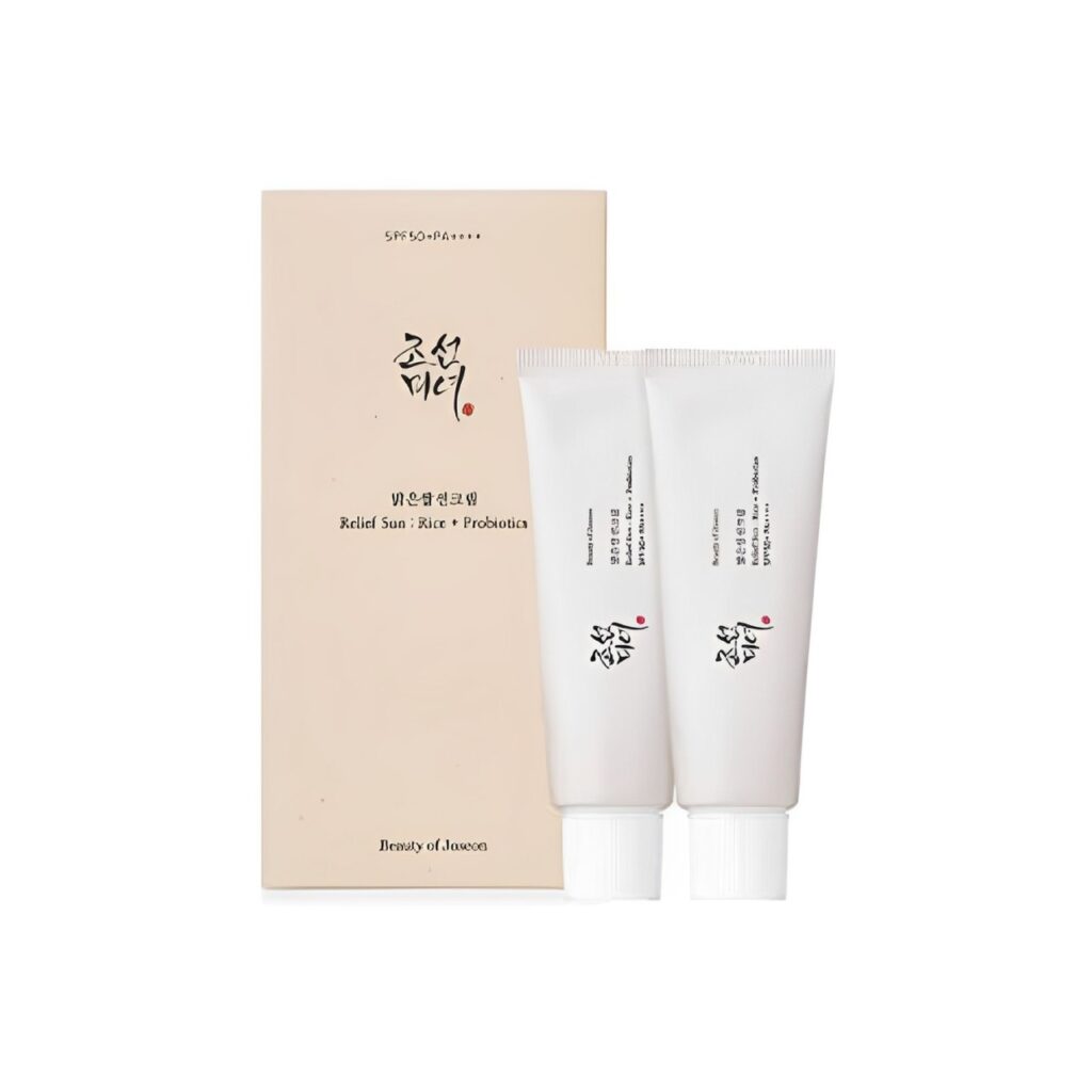 [Beauty of Joseon] Two tubes of skincare cream with SPF 50+ PA++++ protection, placed next to their beige packaging box which has Korean text and the product name ‘Radiant Skin Rice + Probiotics’.