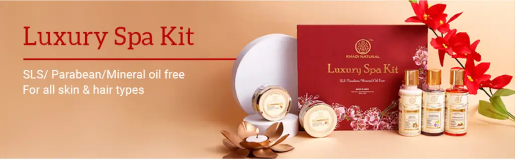 Luxury spa kit with various skincare products on a beige background with red floral accents.